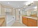 Primary bathroom featuring dual vanities, walk-in shower, and a garden tub at 1518 Orrington Payne Pl, Casselberry, FL 32707