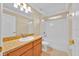 Bright bathroom features a tub/shower combo and wood vanity at 1518 Orrington Payne Pl, Casselberry, FL 32707