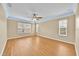 A spacious bedroom shows off wood-look floors, multiple windows, and light trim at 1518 Orrington Payne Pl, Casselberry, FL 32707