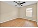 Bright bedroom featuring wood-look flooring, a ceiling fan and a sunny window at 1518 Orrington Payne Pl, Casselberry, FL 32707