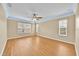 Spacious room with hardwood floors, crown molding, and abundant natural light, creating a bright and inviting atmosphere at 1518 Orrington Payne Pl, Casselberry, FL 32707