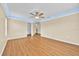 Large and versatile room with hardwood floors, crown molding, ceiling fan, and a bright, open space offering many possibilities at 1518 Orrington Payne Pl, Casselberry, FL 32707