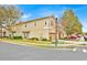 Two-story townhome featuring a beige exterior, attached garage, manicured landscaping and mature trees at 1518 Orrington Payne Pl, Casselberry, FL 32707