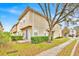 Two story townhome exterior shows well maintained landscaping and a charming paved driveway and walkway at 1518 Orrington Payne Pl, Casselberry, FL 32707