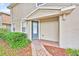 Inviting front entrance with a blue-grey door, brick walkway, and lush, well-maintained landscaping at 1518 Orrington Payne Pl, Casselberry, FL 32707