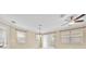 Bright living room featuring neutral paint, many windows with blinds, and contemporary ceiling fans at 1518 Orrington Payne Pl, Casselberry, FL 32707