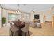 Open-concept living room with a dining table, comfortable sofa, and sliding glass doors offering seamless indoor-outdoor living at 1518 Orrington Payne Pl, Casselberry, FL 32707