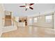 Bright and airy living space featuring tile floors, staircase, and seamless transition to the kitchen at 1518 Orrington Payne Pl, Casselberry, FL 32707