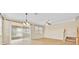 Bright living room features sliding glass doors to the outside, with a ceiling fan and staircase to the next floor at 1518 Orrington Payne Pl, Casselberry, FL 32707