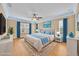 Well-lit main bedroom with a ceiling fan, stylish rug, and blue accents creating a serene and inviting atmosphere at 1518 Orrington Payne Pl, Casselberry, FL 32707