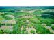 Expansive aerial view of the property, showcasing lush greenery and rolling fields at 15345 Rockridge Rd, Polk City, FL 33868