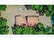 Aerial view of the home with a brown roof, mature landscaping, and a trailer parked on the property at 15345 Rockridge Rd, Polk City, FL 33868