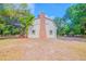 View of the back exterior highlighting its brick chimney and windows at 15345 Rockridge Rd, Polk City, FL 33868