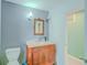 Classic bathroom featuring a vanity with an ornate wood cabinet, stone countertop, and sconce lighting at 15345 Rockridge Rd, Polk City, FL 33868