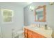 Bright bathroom featuring a vintage vanity with marble countertop and traditional fixtures at 15345 Rockridge Rd, Polk City, FL 33868