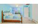 Bright bedroom with a wrought iron bed frame, complemented by light blue walls and natural light from the window at 15345 Rockridge Rd, Polk City, FL 33868