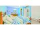Cozy bedroom featuring a colorful zig-zag comforter, light blue walls, and comfortable, inviting decor at 15345 Rockridge Rd, Polk City, FL 33868