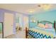 Well-lit bedroom features wood-look floors, pastel walls, and good natural light at 15345 Rockridge Rd, Polk City, FL 33868