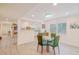 Dining area with a glass table with chairs, with views into the kitchen at 15345 Rockridge Rd, Polk City, FL 33868