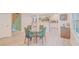 Dining area with a glass table with chairs, with views into the kitchen at 15345 Rockridge Rd, Polk City, FL 33868