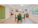 Dining area with a glass table with chairs, with views into the kitchen at 15345 Rockridge Rd, Polk City, FL 33868
