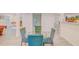 Dining area that has a glass table with chairs, with views into the kitchen at 15345 Rockridge Rd, Polk City, FL 33868