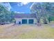Detached garage with two bays, providing secure parking and extra storage space at 15345 Rockridge Rd, Polk City, FL 33868