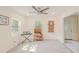 Sunlit living room featuring light-colored flooring and a white front door at 15345 Rockridge Rd, Polk City, FL 33868