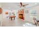 Bright living room with a brick fireplace, ceiling fans, and a pool table at 15345 Rockridge Rd, Polk City, FL 33868