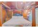 Stunning main bedroom featuring a wooden ceiling, exposed beams and a beautiful king bed at 15345 Rockridge Rd, Polk City, FL 33868