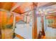 Unique main bedroom features a four poster bed, wood beams and paneling, hardwood floors, and chandelier at 15345 Rockridge Rd, Polk City, FL 33868