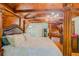 Unique main bedroom features a four poster bed, wood beams and paneling, hardwood floors, and chandelier at 15345 Rockridge Rd, Polk City, FL 33868