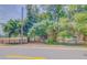 Charming property view featuring mature trees, fencing and street access at 15345 Rockridge Rd, Polk City, FL 33868