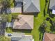 Aerial view of a single-Gathering home featuring mature trees, lush lawn, brick paver driveway and neutral color scheme at 159 Ventana Dr, Kissimmee, FL 34759