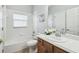 Bathroom featuring a tub/shower, a large window, a sink, and a wood vanity at 159 Ventana Dr, Kissimmee, FL 34759