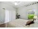 Bright bedroom featuring wood floors, a ceiling fan, and a garden view at 159 Ventana Dr, Kissimmee, FL 34759