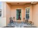 Welcoming front entrance featuring decorative chairs, a 'welcome' mat, and a glimpse into the home's interior at 159 Ventana Dr, Kissimmee, FL 34759