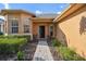 Inviting front porch with charming seating, decorative plants, and a pathway leading to the open front door at 159 Ventana Dr, Kissimmee, FL 34759