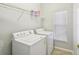 Laundry room with washer, dryer, and shelving for storage at 159 Ventana Dr, Kissimmee, FL 34759