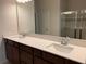 Elegant bathroom with double sink vanity, quartz countertop, and glass enclosed shower at 1892 Spring Shower Cir, Kissimmee, FL 34744