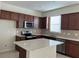 A kitchen with wooden cabinets, a stainless steel microwave, and a central island at 1892 Spring Shower Cir, Kissimmee, FL 34744