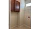 Convenient laundry area with tile floors, overhead cabinets, and space for appliances at 1892 Spring Shower Cir, Kissimmee, FL 34744