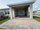 Outdoor patio features brick pavers, columns, sink, and sliding glass door to the home at 1892 Spring Shower Cir, Kissimmee, FL 34744