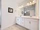 Bathroom featuring double sink vanity with a large framed mirror, and tiled floors at 1930 Molise Dr, Poinciana, FL 34759