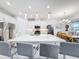 Open-concept kitchen with a large island, modern bar stools, and pendant lighting at 1930 Molise Dr, Poinciana, FL 34759