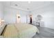 Bright main bedroom featuring a neutral color scheme, tray ceiling, and an ensuite bathroom at 1930 Molise Dr, Poinciana, FL 34759