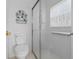 This bathroom features a glass shower door and white tiled walls at 196 Knoll Wood Dr, Kissimmee, FL 34759