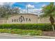 The Solivita community sign welcomes residents and visitors with beautiful landscaping at 196 Knoll Wood Dr, Kissimmee, FL 34759