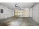 Spacious garage featuring storage cabinets and an automatic garage door at 196 Knoll Wood Dr, Kissimmee, FL 34759