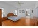 Main bedroom with hardwood floors, ceiling fan, and doorway to the main bathroom at 196 Knoll Wood Dr, Kissimmee, FL 34759